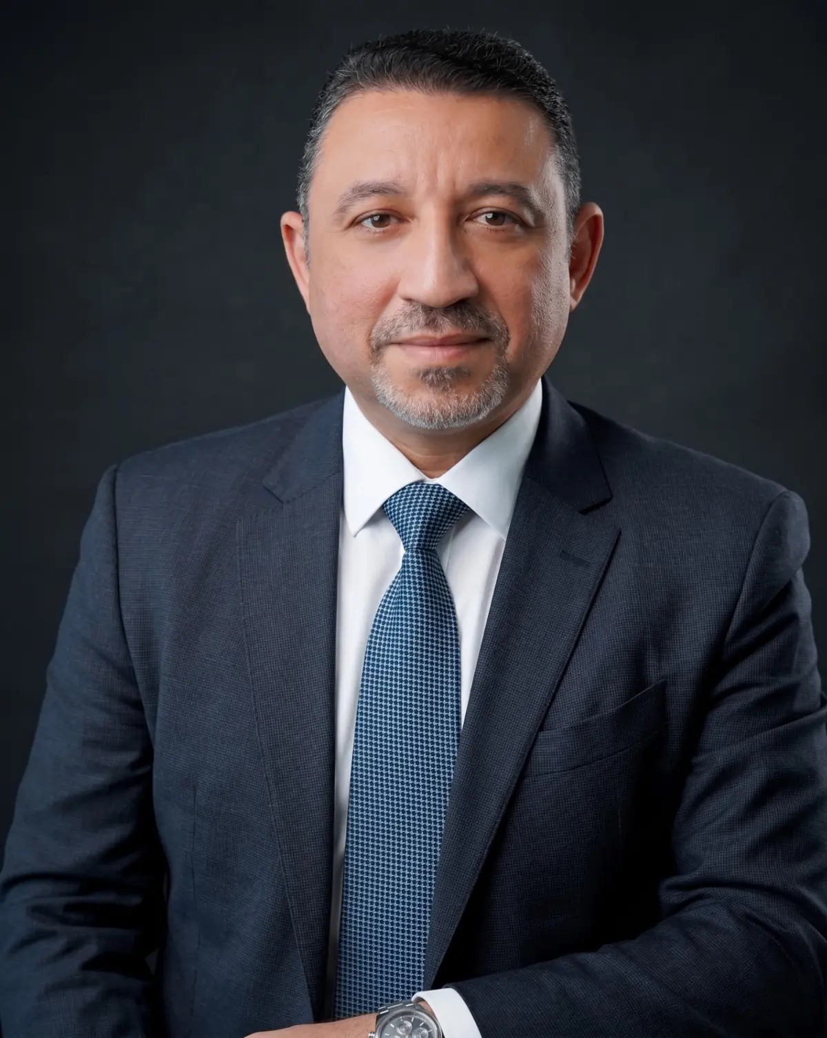 Dr. Walid Elsayes, healthcare operations and transformation executive, in a dark suit against a plain background